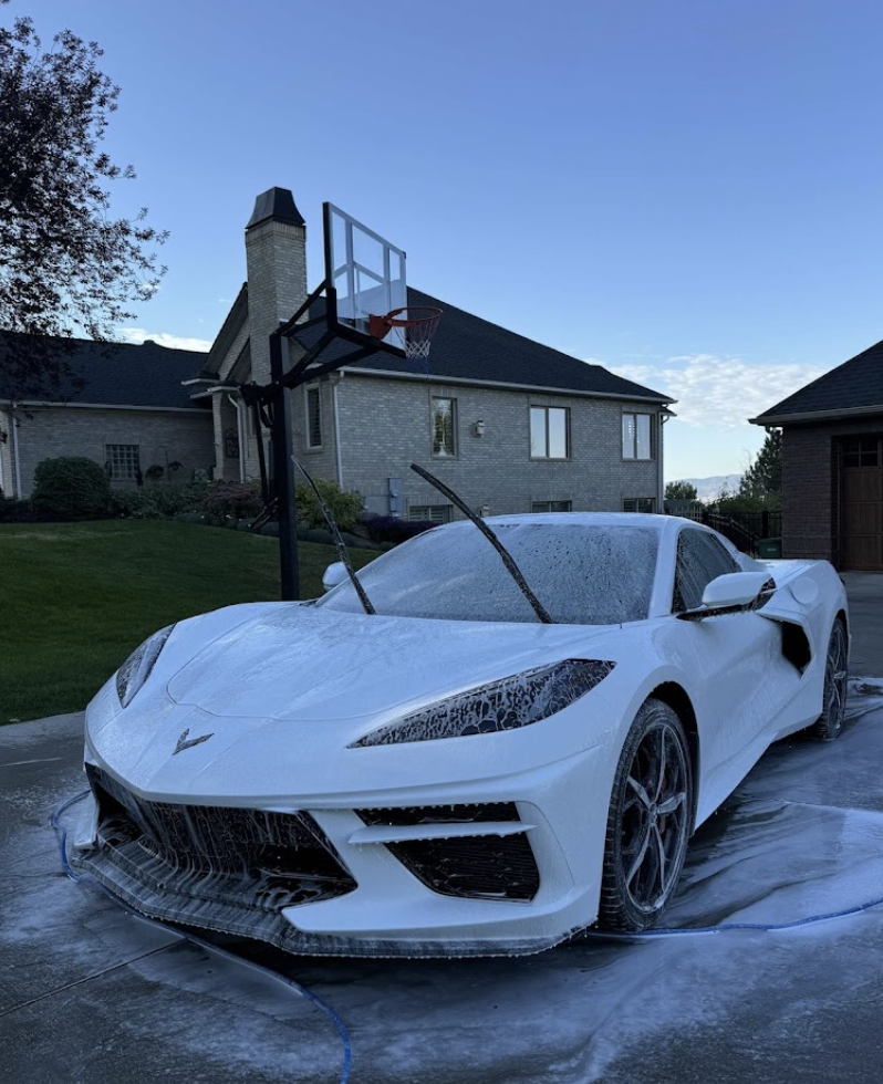 White Corvette covered in foam during a mobile exterior detail in Utah Valley
